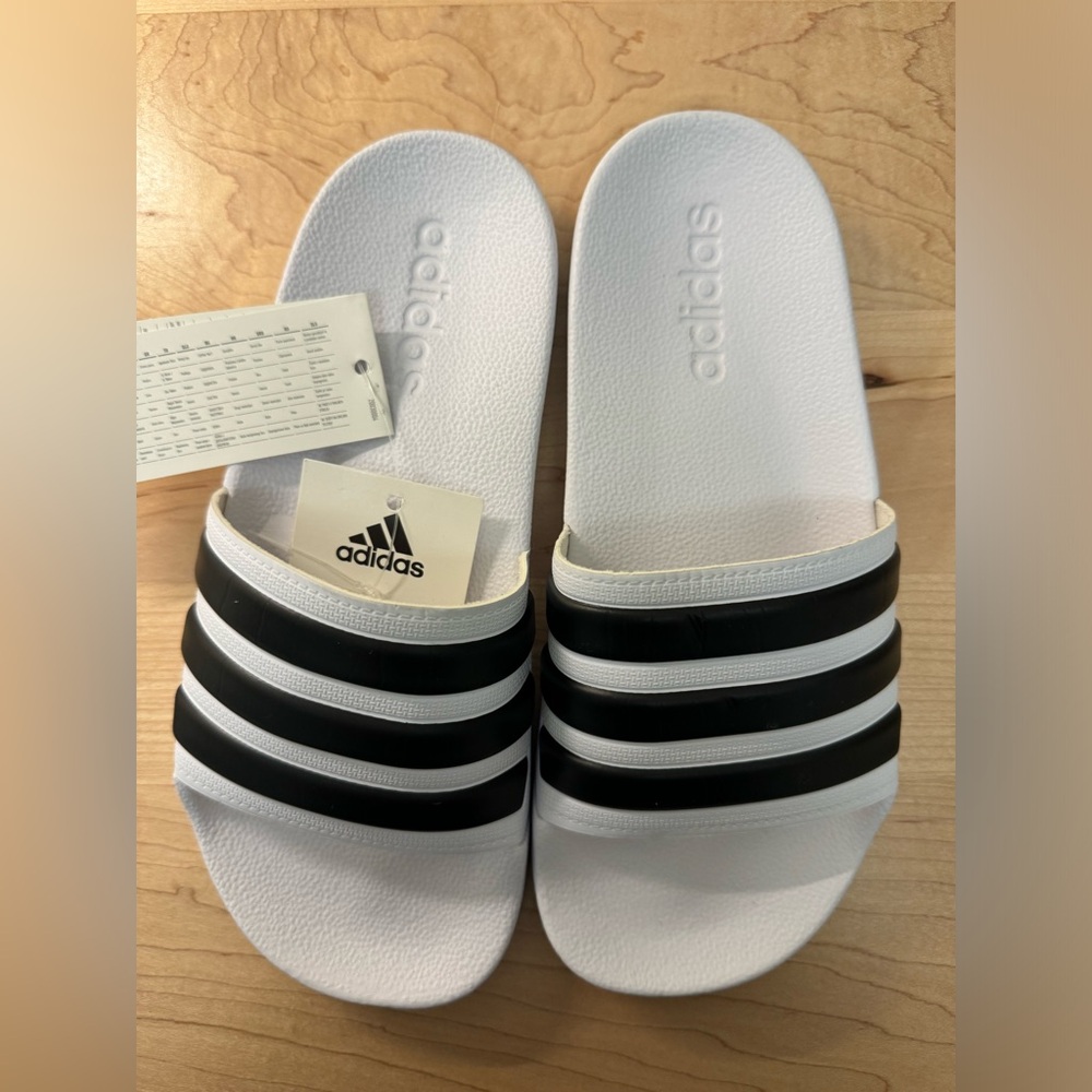 Adidas slippers. Never worn. Tags attached.
